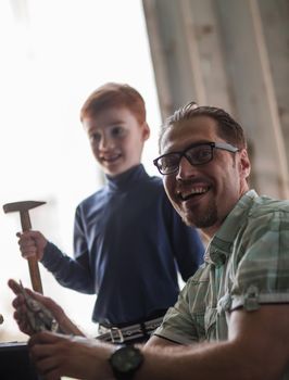 close up.portrait of father and son in the home garage