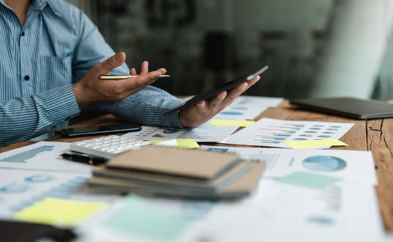 Businessman accountant or financial expert analyze business report graph and finance chart at corporate office. Concept of finance economy, banking business and stock market research.