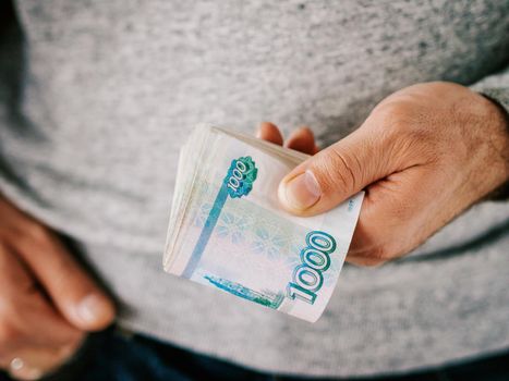 Hands hold russian rubles. Selective focus. Shallow DOF