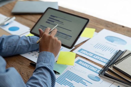 Businessman accountant or financial expert analyze business report graph and finance chart at corporate office. Concept of finance economy, banking business and stock market research