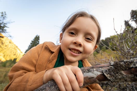 Close-up emotional portrait of a 5-year-old girl on a hike in nature.
