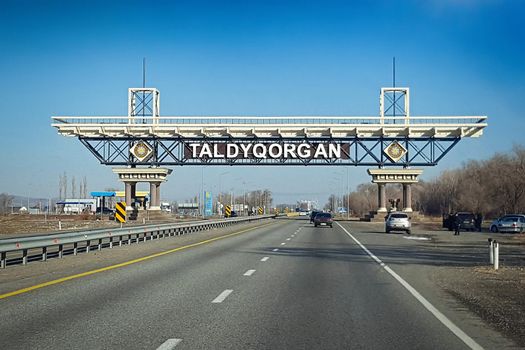 Entrance road stele of the city of Taldykorgan with the inscription TALDYQORGAN in Kazakhstan. Taldykorgan, Kazakhstan - November, 27, 2021