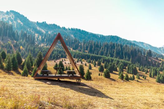 Modern gazebo for tourists in mountains landscape with copy space.