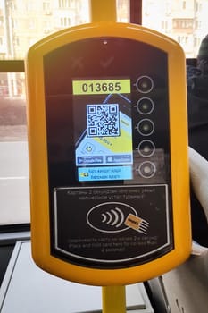 Onay yellow validator in Kazakhstan city bus. Contactless electronic payment in public transport of the city of Almaty. Almaty, Kazakhstan - December, 23, 2021