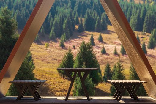 An equipped place under a roof in nature in the mountains for a comfortable camping.