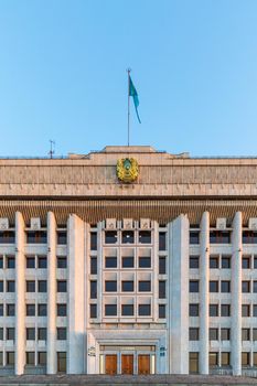 Administration of the city of Almaty with the coat of arms and flag of the Republic of Kazakhstan. Almaty, Kazakhstan - September 05, 2021