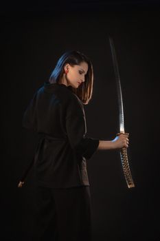 Mysterious young beautiful woman with sharp blade in asian style.