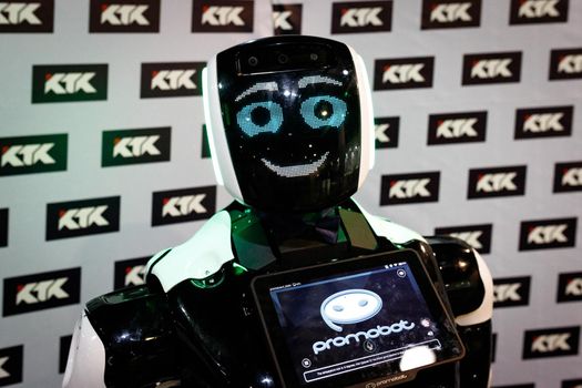 Smiling promobot robot looking at the camera at the robot festival. Almaty, Kazakhstan - February 19, 2022