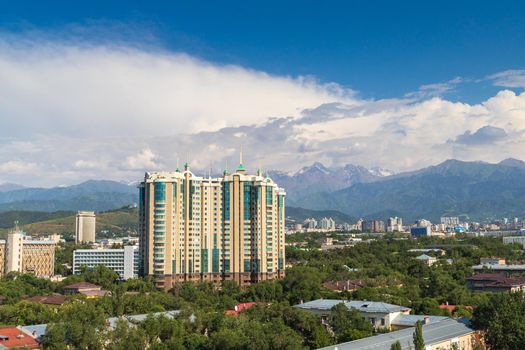Modern multi-storey residential complex CAPITAL CENTER among the old buildings of the Medeu district of Almaty. Almaty, Kazakhstan - July 02, 2021