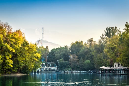 General view of the central park of Almaty with a small lake in the middle and some attractions. Almaty, Kazakhstan - Oktober, 14, 2021