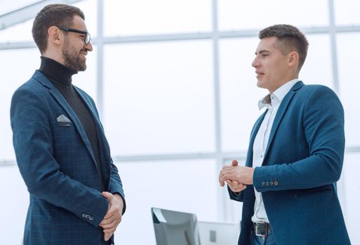 business team discussing work issues standing in the office . photo with a copy-space