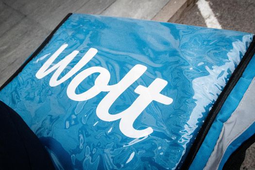 Close-up on the WOLT logo on a blue box - an international food delivery service. Almaty, Kazakhstan - September 20, 2021