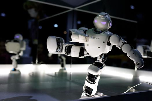 Robot keeps balance while standing on one leg at the exhibition of robots. Almaty, Kazakhstan - February 19, 2022