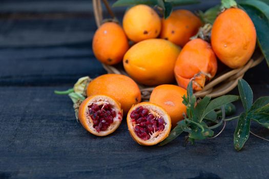 harvest of orange fruits of wild passion fruit on wood