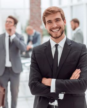 close up. smiling business man standing in a modern office