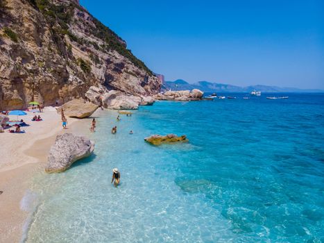 Golfo di Orosei Sardina, Asian women on the beach Sardinia Italy, a young girl on vacation Sardinia Italy, woman playing in the ocean with crystal clear blue water,