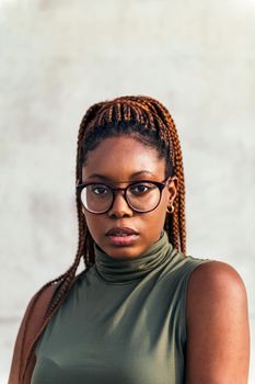vertical portrait of a young black woman with glasses, concept of youth and racial diversity, copy space for text