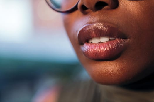 close-up detail of the full-lipped mouth of a black woman, copy space for text