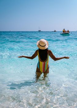 Golfo di Orosei Sardina, Asian women on the beach Sardinia Italy, a young girl on vacation Sardinia Italy, woman playing in the ocean with crystal clear blue water,