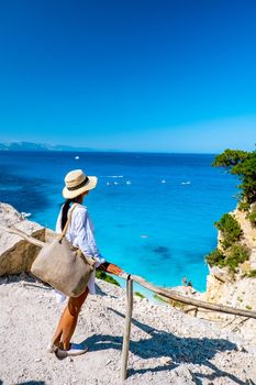 Golfo di Orosei Sardina, Asian women on the beach Sardinia Italy, a young girl on vacation Sardinia Italy, woman playing in the ocean with crystal clear blue water,