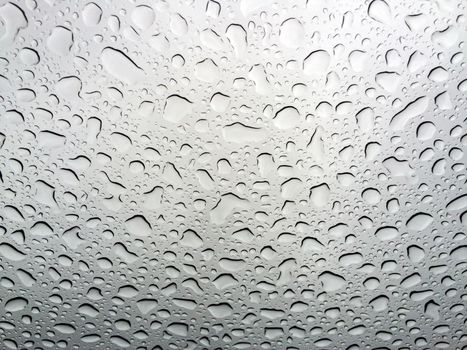 Abstract texture of water drops on a glass.