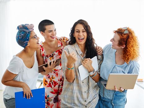 Happy young woman girls friends with tablet and laptop in the office