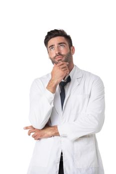 Young male medical doctor with stethoscope thinking holding chin isolated on white background studio portrait