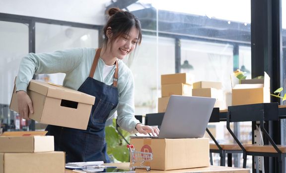 Starting small businesses SME owners female entrepreneurs check online orders to prepare to pack the boxes, sell to customers, sme business ideas online..