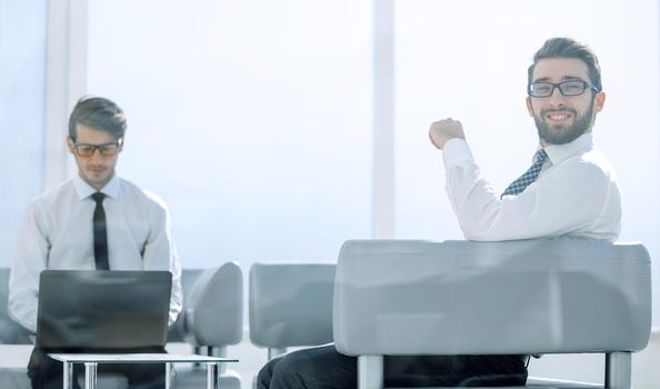 business background.employees sitting in the office lobby .photo with copy space