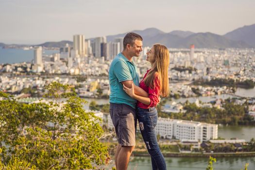 Happy couple tourists on the background of Nha Trang city. Travel to Vietnam Concept.