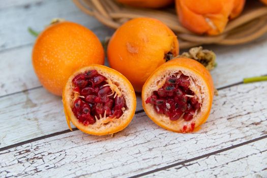 harvest of orange fruits of wild passion fruit on wood