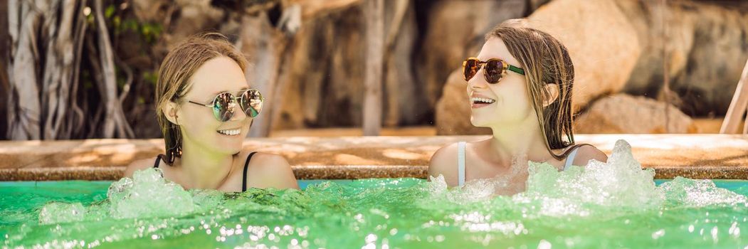 Portrait of two beautiful women in jacuzzi spa. BANNER, LONG FORMAT