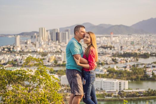 Happy couple tourists on the background of Nha Trang city. Travel to Vietnam Concept.