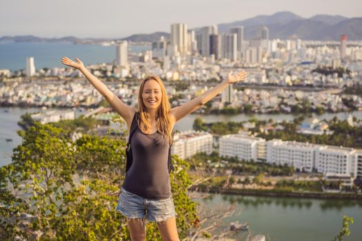 Woman tourist on the background of Nha Trang city. Travel to Vietnam Concept.