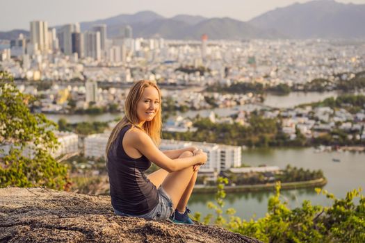 Woman tourist on the background of Nha Trang city. Travel to Vietnam Concept.