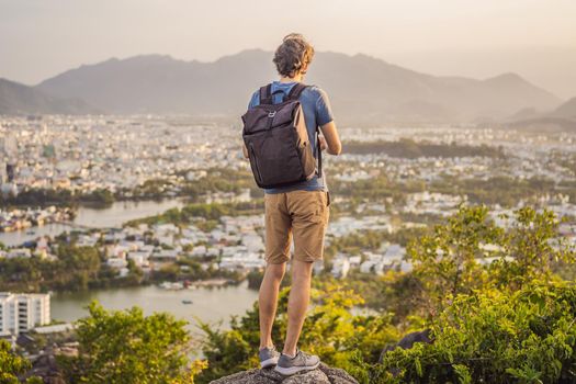 Man tourist on the background of Nha Trang city. Travel to Vietnam Concept.