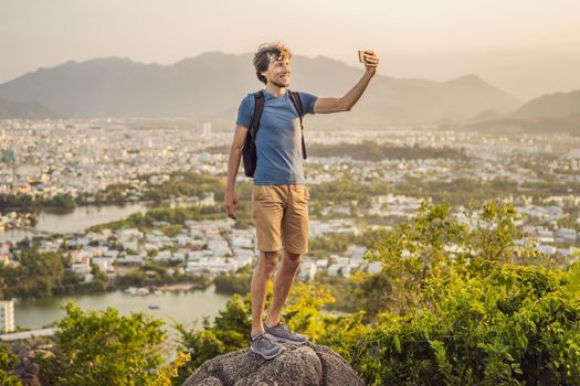 Man tourist on the background of Nha Trang city. Travel to Vietnam Concept.