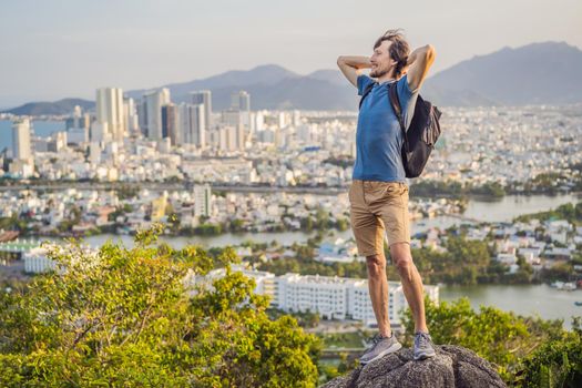 Man tourist on the background of Nha Trang city. Travel to Vietnam Concept.