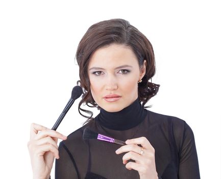 Beautiful woman with makeup brush near her face - isolated on white