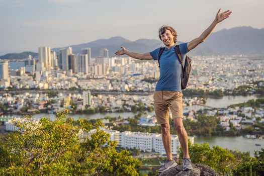 Man tourist on the background of Nha Trang city. Travel to Vietnam Concept.