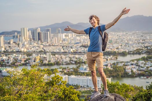 Man tourist on the background of Nha Trang city. Travel to Vietnam Concept.