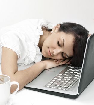 closeup.young business woman sleeping on the laptop keyboard .isolated on white