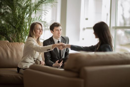 The lawyer of the company and the handshake of business partners after discussing a new contract in a modern office