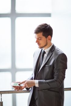Young business man talking on cell phone at modern office