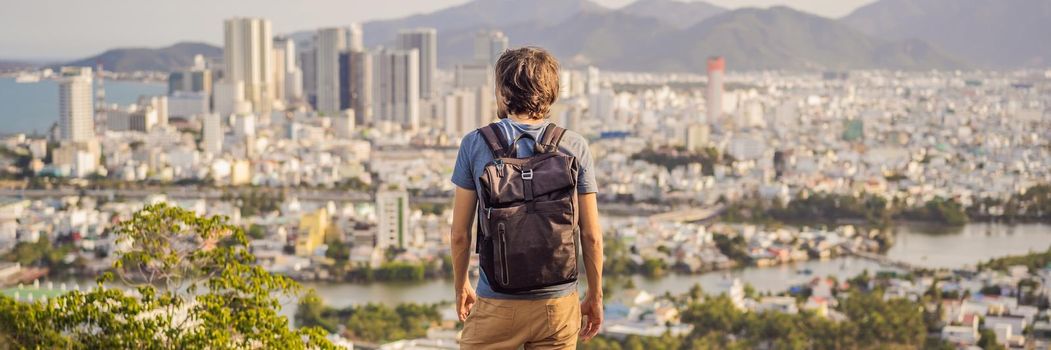 Man tourist on the background of Nha Trang city. Travel to Vietnam Concept. BANNER, LONG FORMAT