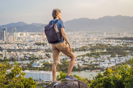 Man tourist on the background of Nha Trang city. Travel to Vietnam Concept.