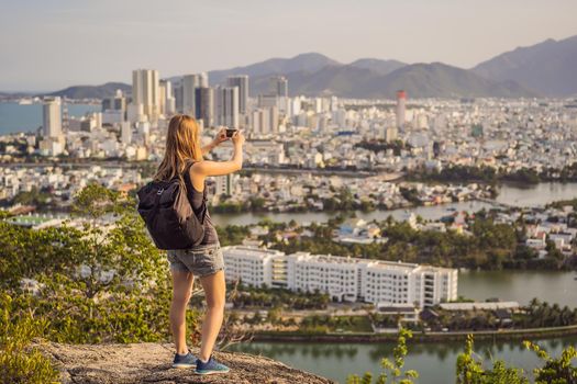 Woman tourist on the background of Nha Trang city. Travel to Vietnam Concept.