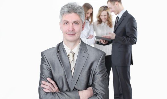 portrait of successful businessman on background of employees.isolated on a white background.