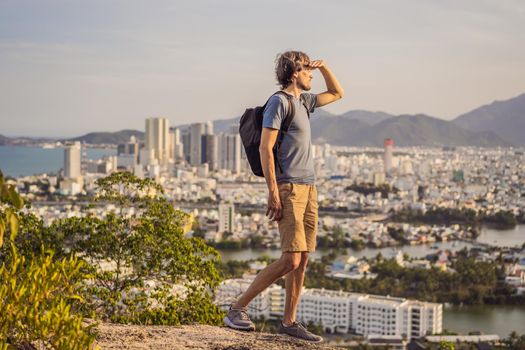 Man tourist on the background of Nha Trang city. Travel to Vietnam Concept.