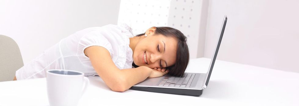 closeup.young business woman sleeping on the laptop keyboard .isolated on white